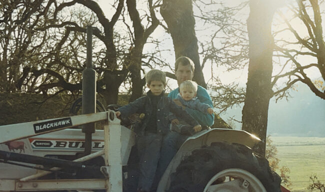 Michael and his two sons on the tractor