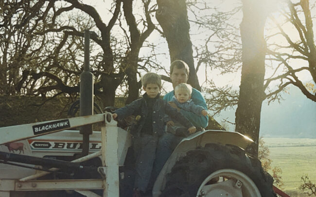 Michael and his two sons on the tractor